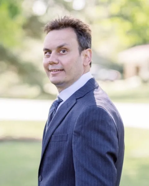 Chris Feyrer, outdoors in a navy suit